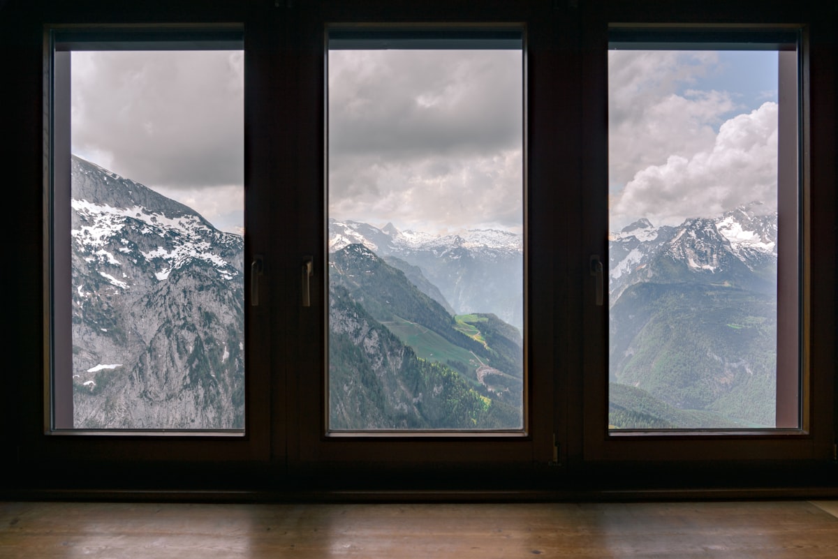 fogs covered snow capped mountain range view outside window related to Elevate Your Windows: The Ultimate Guide to Window Treatments with Valances