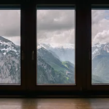 fogs covered snow capped mountain range view outside window related to Elevate Your Windows: The Ultimate Guide to Window Treatments with Valances