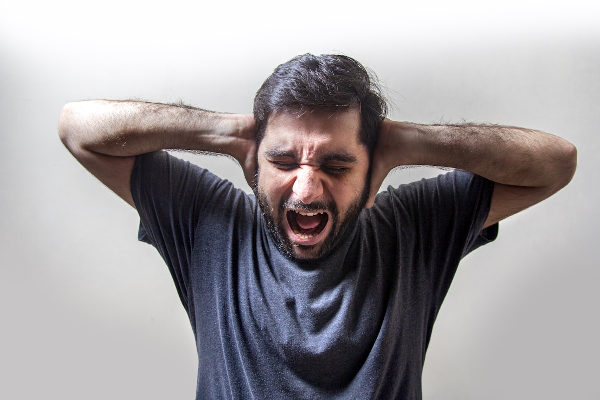 Frustrated Young Man Screaming in Fear related to What Men Want to Hear in Bed: Unlocking the Secrets to Satisfying Intimacy
