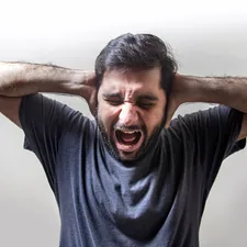 Frustrated Young Man Screaming in Fear related to What Men Want to Hear in Bed: Unlocking the Secrets to Satisfying Intimacy