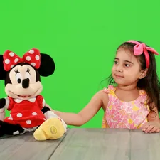 girl in minnie mouse dress sitting beside minnie mouse plush toy related to Minnie Mouse Bed Set for Toddlers: A Magical Sleeping Experience
