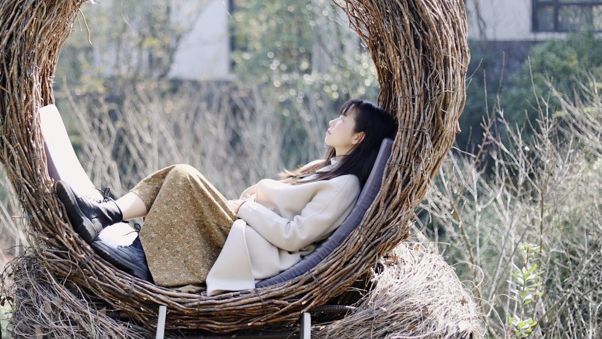 girl in white dress on brown woven basket related to The Cozy Bird Nest Bed