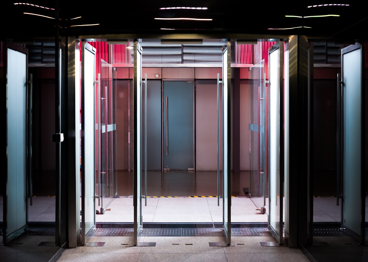 Glass revolving doors with modern interior lighting related to Welcome with Style: The Benefits of Commercial Entryway Mats
