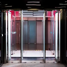 Glass revolving doors with modern interior lighting related to Welcome with Style: The Benefits of Commercial Entryway Mats