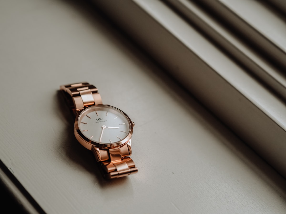 gold and silver round analog watch related to Elegant Simplicity: The Timeless Allure of Black and White Kitchen Valances