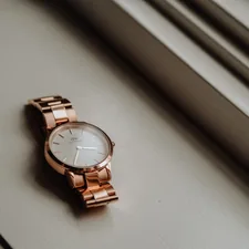 gold and silver round analog watch related to Elegant Simplicity: The Timeless Allure of Black and White Kitchen Valances