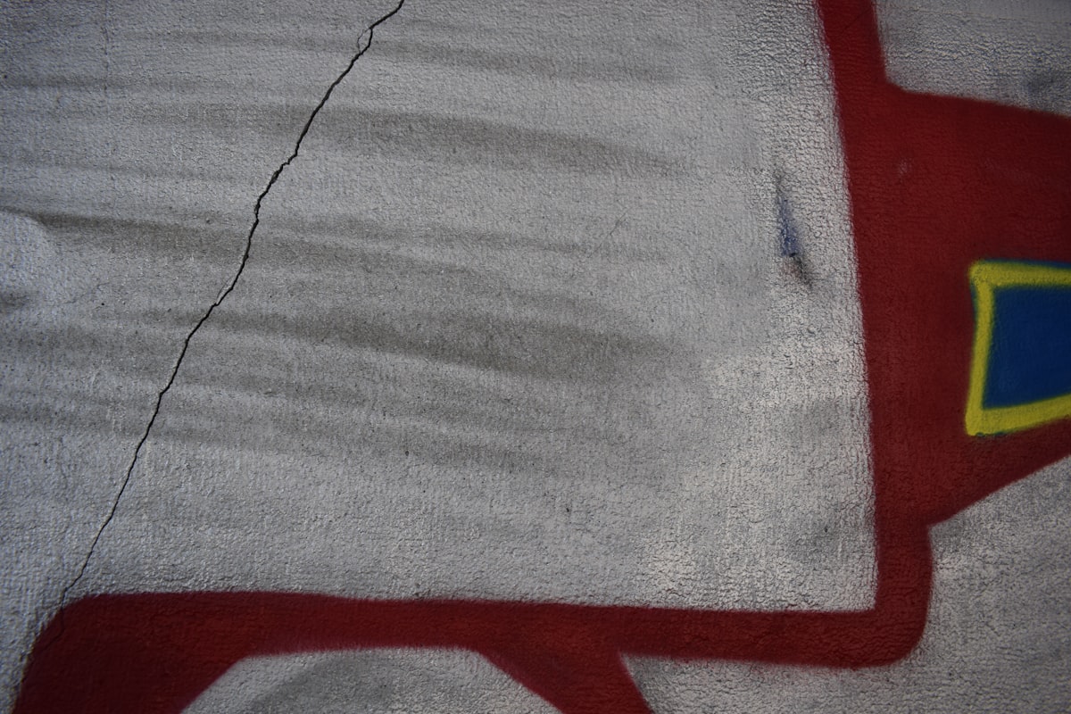 Graffiti art with red and blue elements on wall related to Thomas the Train Toddler Bed Set: A Fun and Cozy Sleeping Solution for Little Engineers
