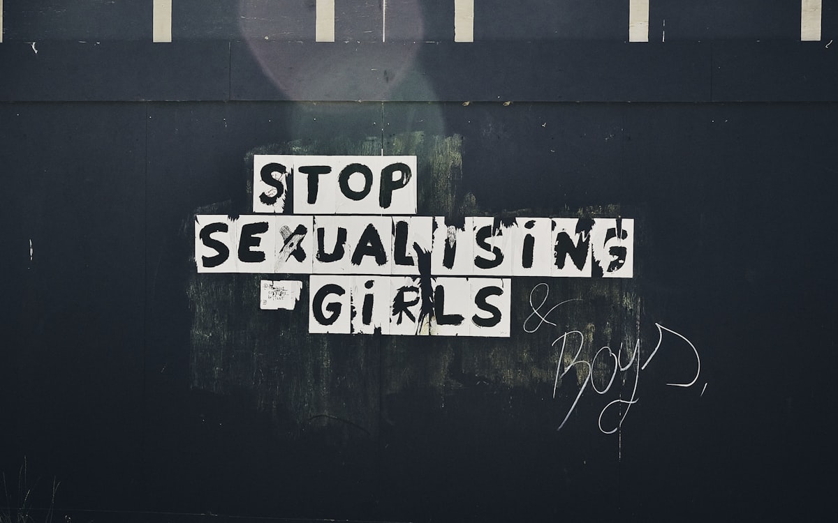 Graffitti on a construction wall at Connswater Community Greenway, County Down (May, 2020). The sign says "Stop Sexualising Girls and Boys." related to Unlocking Confidence: Exploring Sexuality in Bed