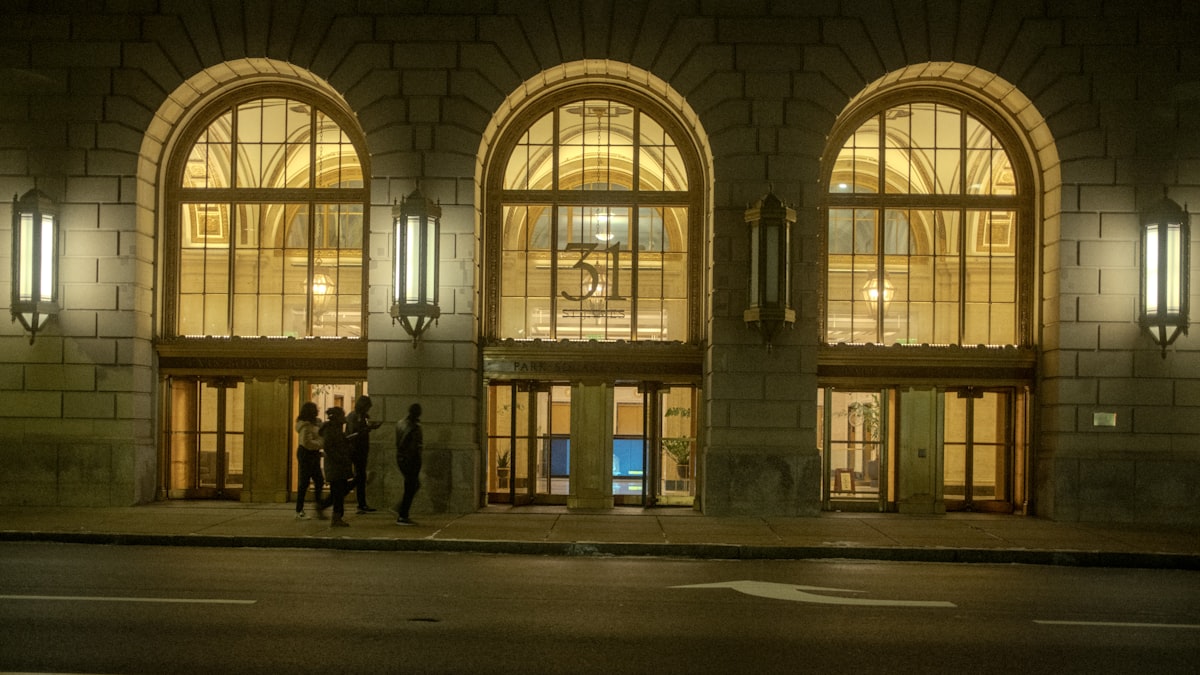 Grand arched entrance of a building at night related to Illuminate Your Entryway: Guide to Lighting Design for Enhanced Welcome