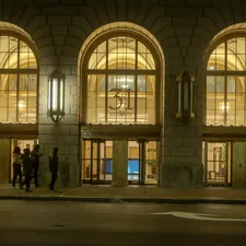 Grand arched entrance of a building at night related to Illuminate Your Entryway: Guide to Lighting Design for Enhanced Welcome