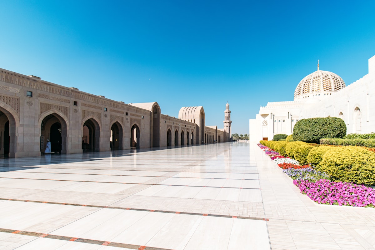 Grand mosque courtyard with arched walkways, dome, and gardens. related to Beautiful Flower Bed Designs for the Front of Your House