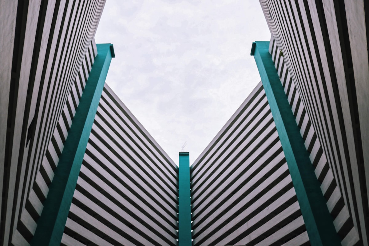 gray concrete building under white clouds during daytime related to Transform Your Bedroom with Black, White, and Turquoise Bedding