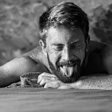 grayscale photo of man lying on wooden surface related to The Complexities of Male Intimacy