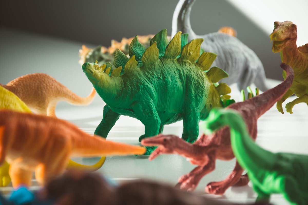 green and orange dragon plastic toy related to Roaring into Sweet Dreams: Circo Dinosaur Bedding for Budding Paleontologists