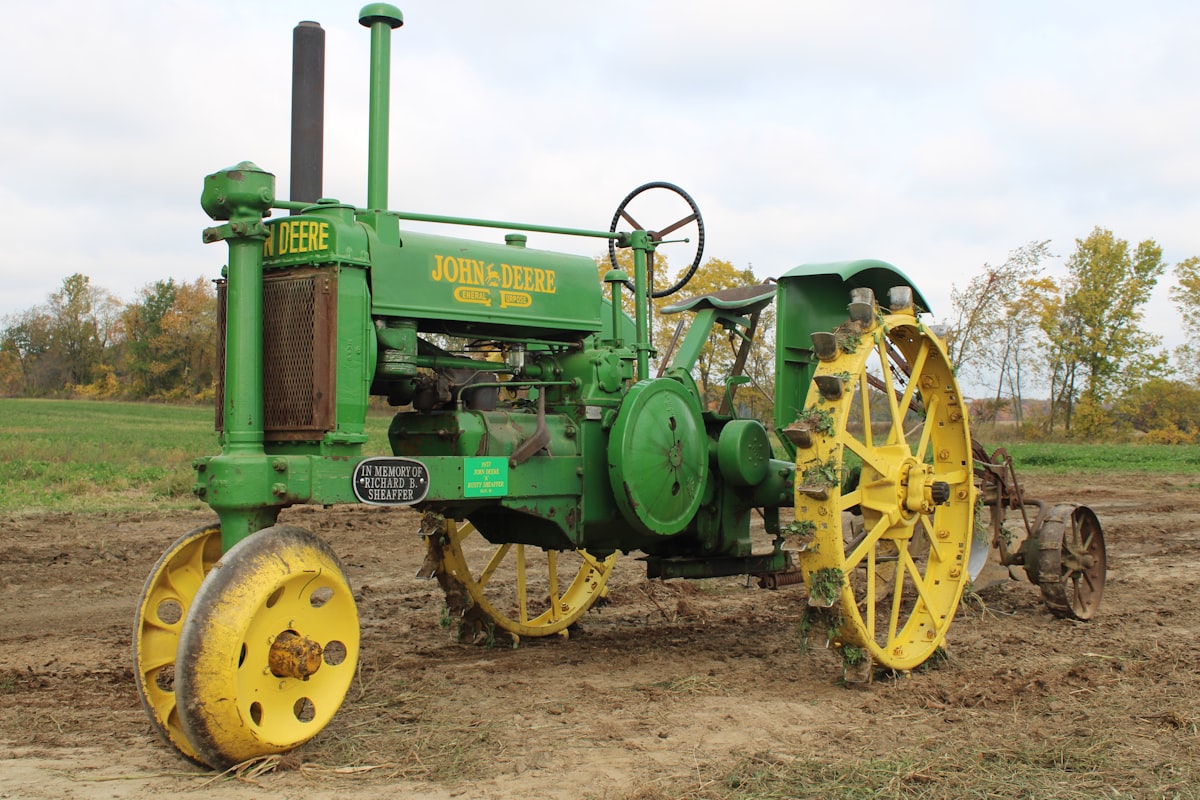 green and yellow tractor on brown field during daytime related to The Ultimate Guide to John Deere Valances: Elevating the Style of Your Farm Equipment