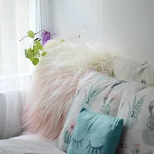 green throw pillow on white couch related to Elevate Your Decor with Faux Leather Valances
