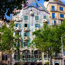 green trees in front of brown concrete building during daytime related to Discover the Charm of Barcelona: Top Bed and Breakfasts to Stay At