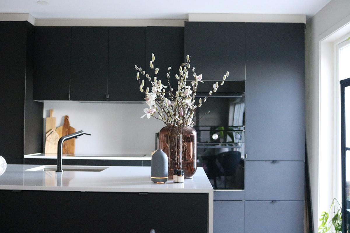 Grey volant diffuser and essential oils add ambiance and transform the kitchen into a relaxing environment. related to Elevate Your Kitchen Style with a Sophisticated Black Kitchen Sideboard