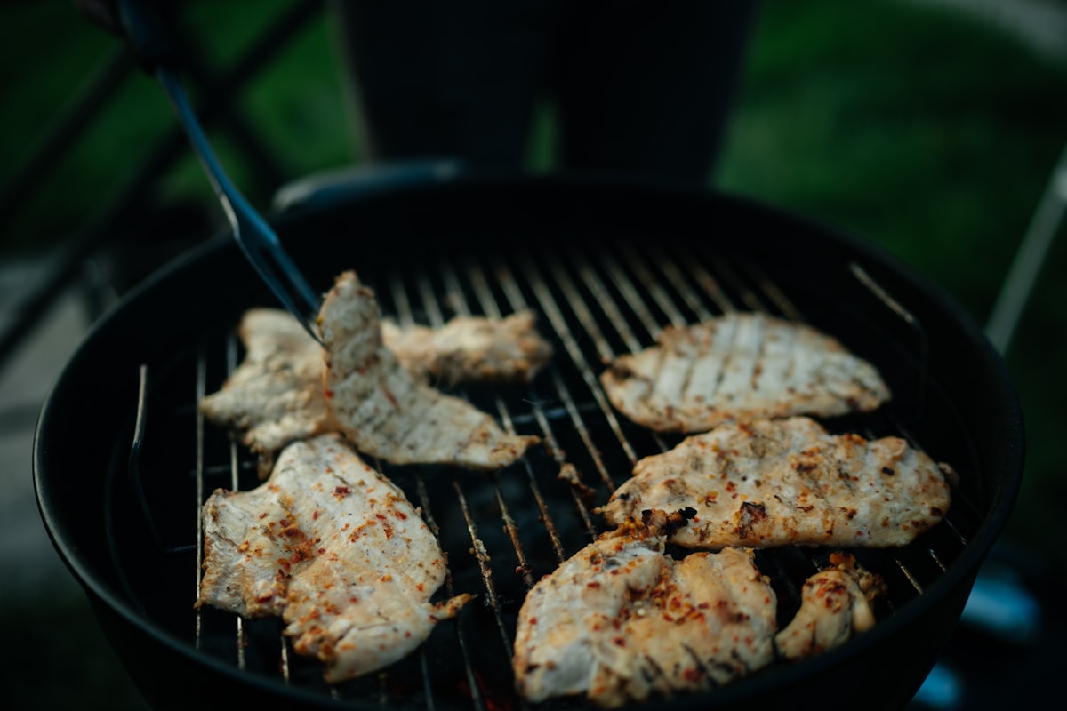 grilled meat on black charcoal grill related to Chiminea with Grill: Your All-in-One Outdoor Cooking Solution