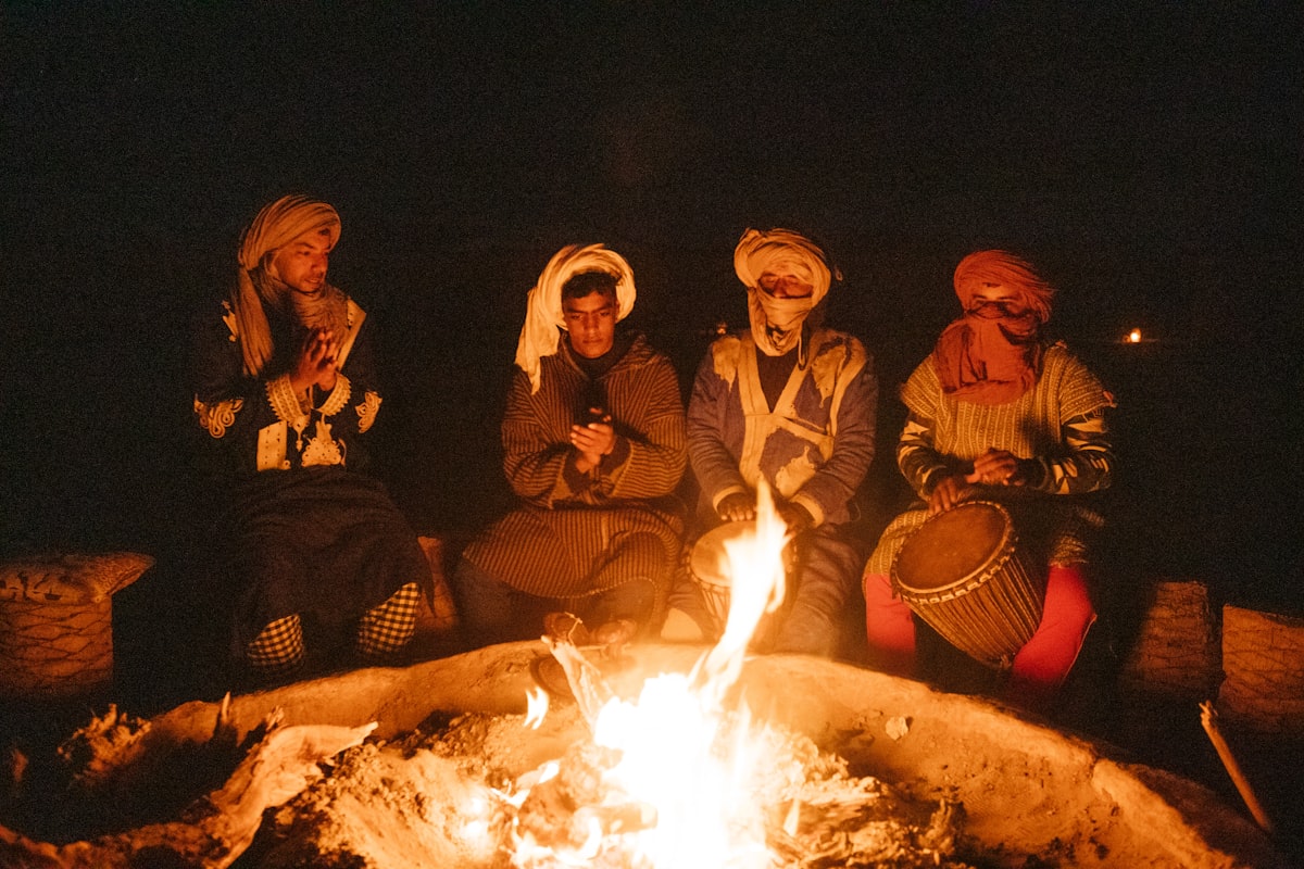 group of people sitting on chair in front of bonfire related to Warming Up with a Touch of Fiesta: The Magic of Mexican Chiminea Fire Pits