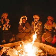 group of people sitting on chair in front of bonfire related to Warming Up with a Touch of Fiesta: The Magic of Mexican Chiminea Fire Pits
