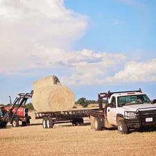 Hauling hay Texas ranch life  related to Bale Bed Trucks for Sale: Find the Perfect Vehicle for Your Farming Needs