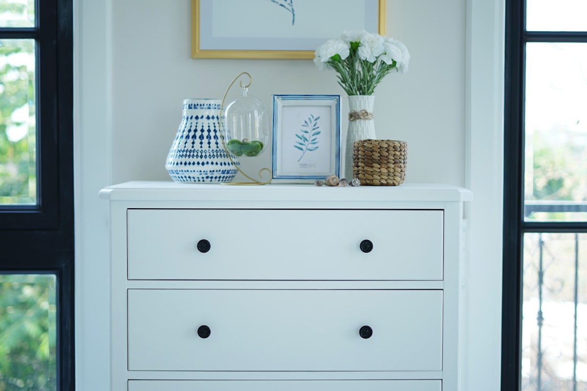 Home interior poster with vertical blue and white metal frame and succulents on white wall background related to Elevate Your Home Decor with the Perfect Sideboard Cabinet White