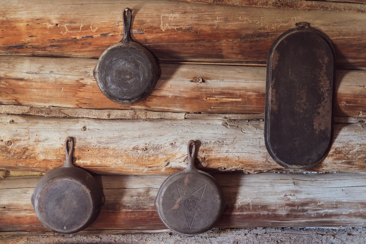 I'll donate this to the internet as a random stock photo of skillets hanging on the wall. I stopped at a small pioneer museum in the very remote town of Fort Rock, Oregon. This is from one of the old pioneer cabins on the property.  related to Rustic Kitchen Valances