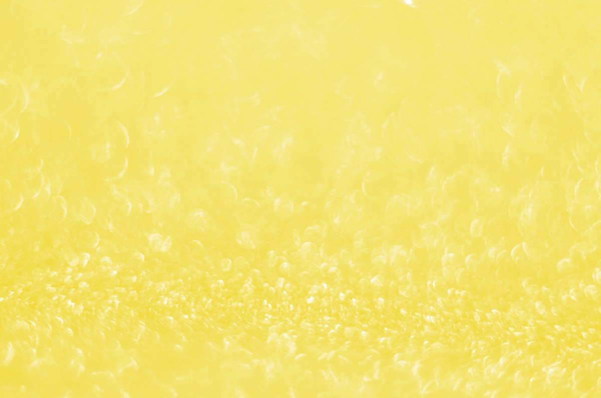 Illuminating Pantone Color Of The Year 2021. Abstract festive bokeh background with shining defocus sparkles. Blurred glitters shimmering dust macro close up, copy space for text logo related to Brighten Up Your Space with Yellow Kitchen Valances