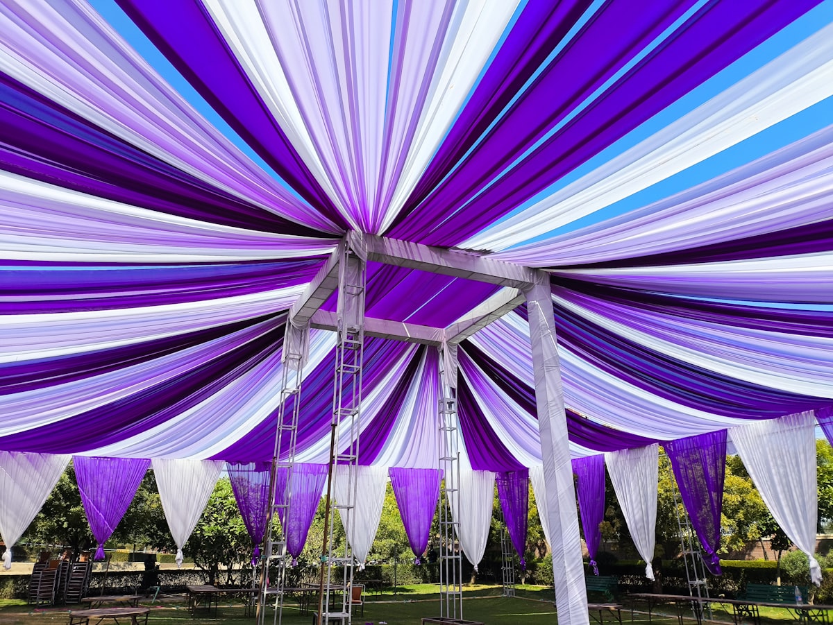 Image of a purple and white tent with a blue sky in the background related to Elegant Purple Valances to Enhance Your Bedroom Decor