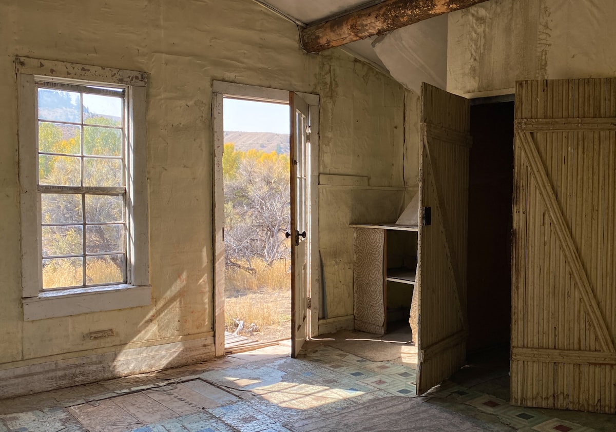 Interior shot of an abandoned house in the Bannack, Montana ghost town with empty cupboards, closets, and an open front door leading to a sagebrush field, September 23, 2020. related to Revamp Your Bedroom with West Elm Beds