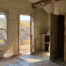 Interior shot of an abandoned house in the Bannack, Montana ghost town with empty cupboards, closets, and an open front door leading to a sagebrush field, September 23, 2020. related to Revamp Your Bedroom with West Elm Beds