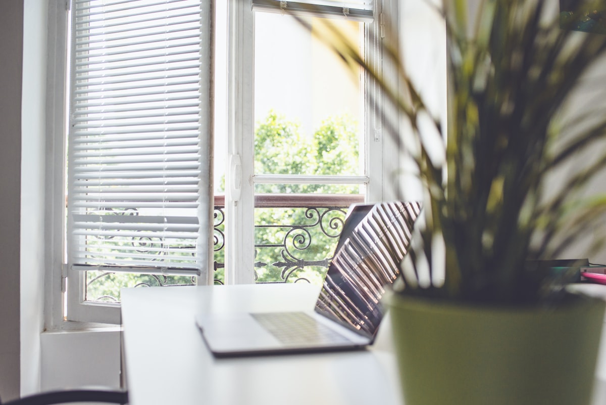 laptop on a desk related to Office Window Valances