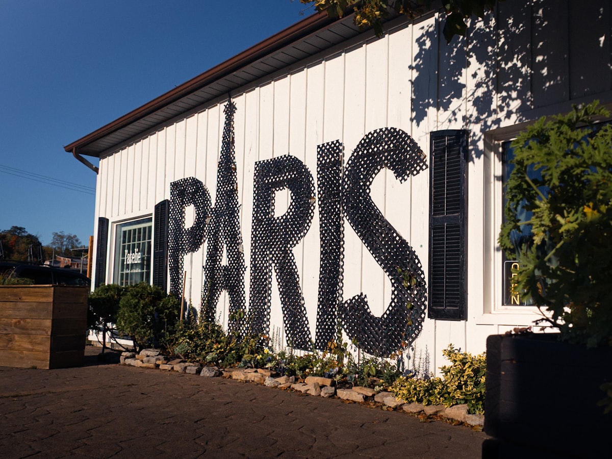 Large "paris" text on white building exterior related to Elegant Bedroom Designs