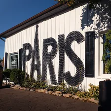Large "paris" text on white building exterior related to Elegant Bedroom Designs