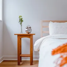 Light and Airy Bedroom with Old clock on Nightstand and colorful pillow related to Brighten Up Your Bedroom with a Yellow Coverlet for Your King-Sized Bed