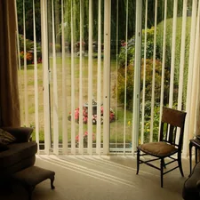 Living room with vertical blinds and garden view related to Vertical Blinds Valance Clips