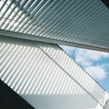 Looking up at a modern, louvered ceiling and sky. related to Valance Over Blinds: Elevate Your Window Treatment Style