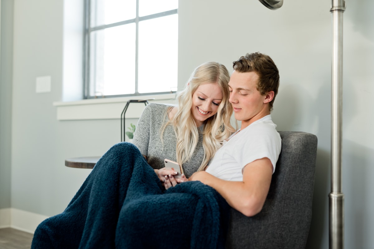 Lovebirds snuggle on the couch related to Cozying Up: The Benefits and History of Cast Iron Chimineas