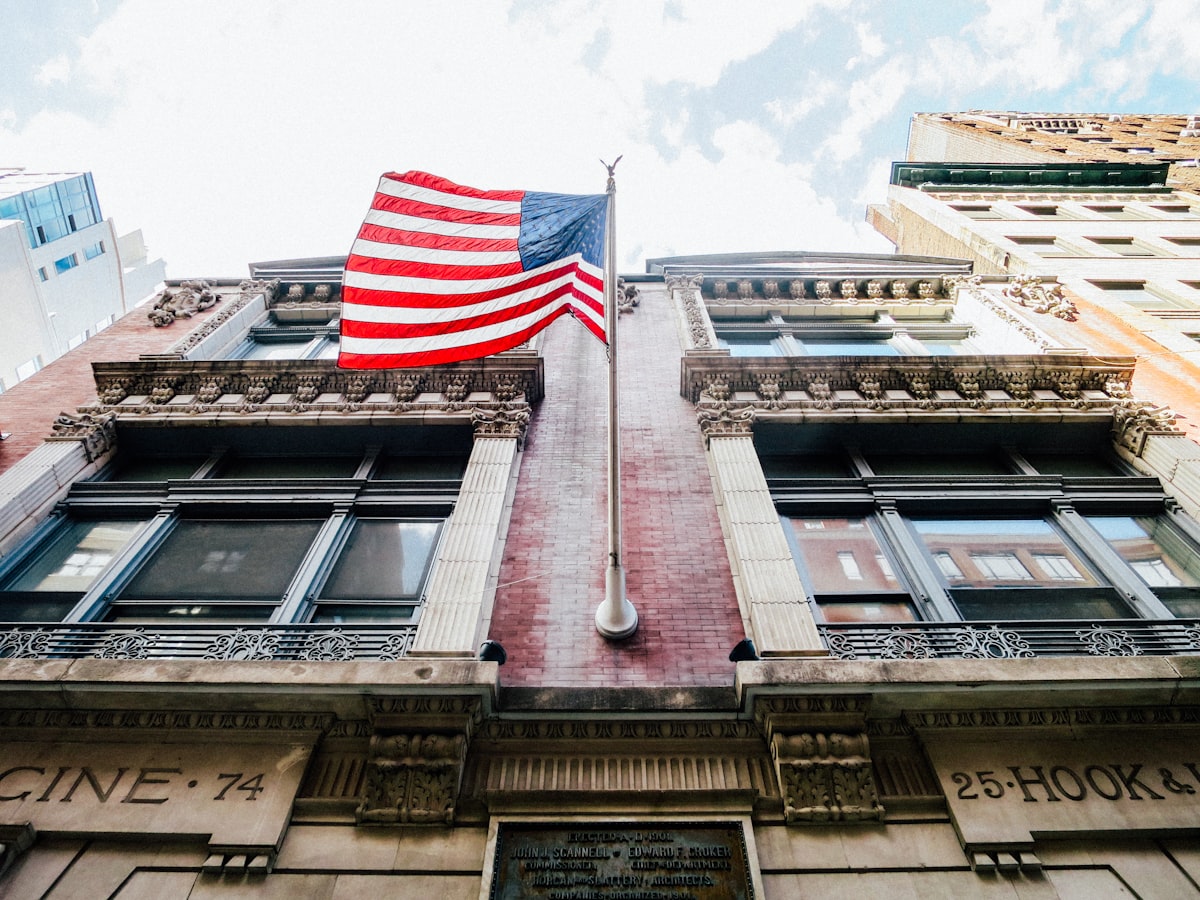 low angle photography of waving U.S.A. flag hang on bricks wall related to The Timeless Charm of American Drew Sideboards