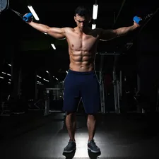 man exercising inside dim room related to The Perfect Chest for the End of Your Bed: Stylish and Functional Storage Solutions