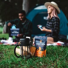 man in black jacket and brown hat sitting on green grass field related to Revolutionizing Your Outdoors: Outdoor Sideboards and Buffets