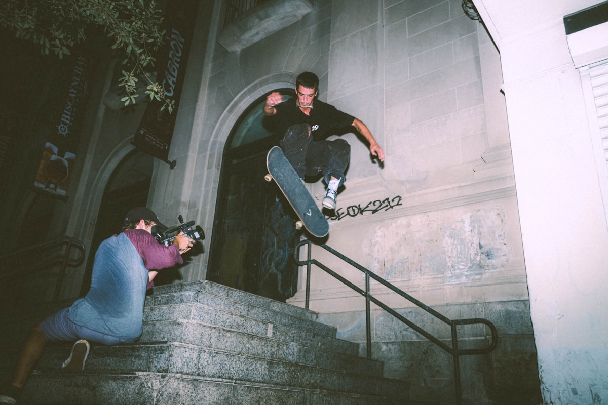 man in black t-shirt and blue denim jeans sitting on stairs related to How to Hang Swag Valances: A Step-by-Step Guide