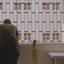 man in gray shirt and blue denim jeans standing near white wooden window related to Making Window Valances