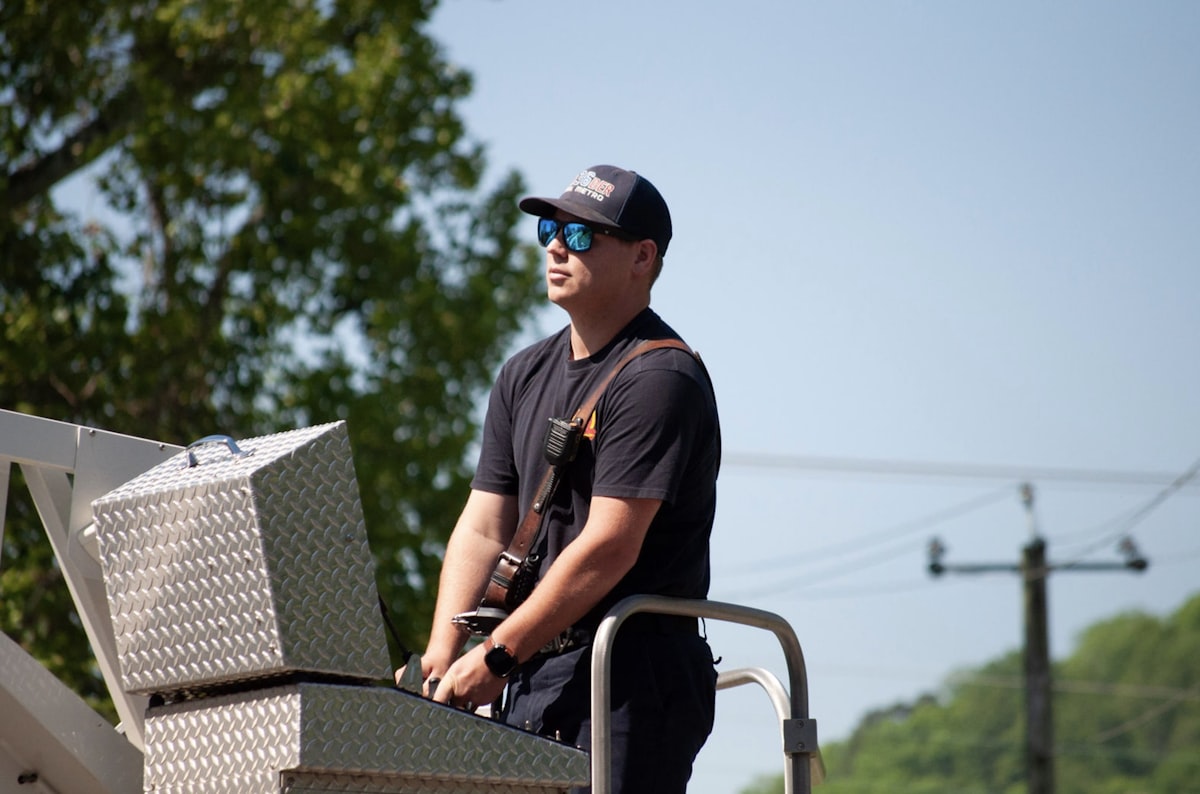 Man in sunglasses on a ladder truck related to Top Tool Boxes for Truck Beds: The Ultimate Guide for Organizing Your Tools