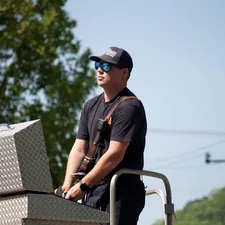 Man in sunglasses on a ladder truck related to Top Tool Boxes for Truck Beds: The Ultimate Guide for Organizing Your Tools