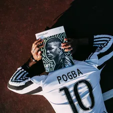 man in white and black adidas jersey shirt holding black and white textile related to The Ultimate Guide to Football Bedding Sets