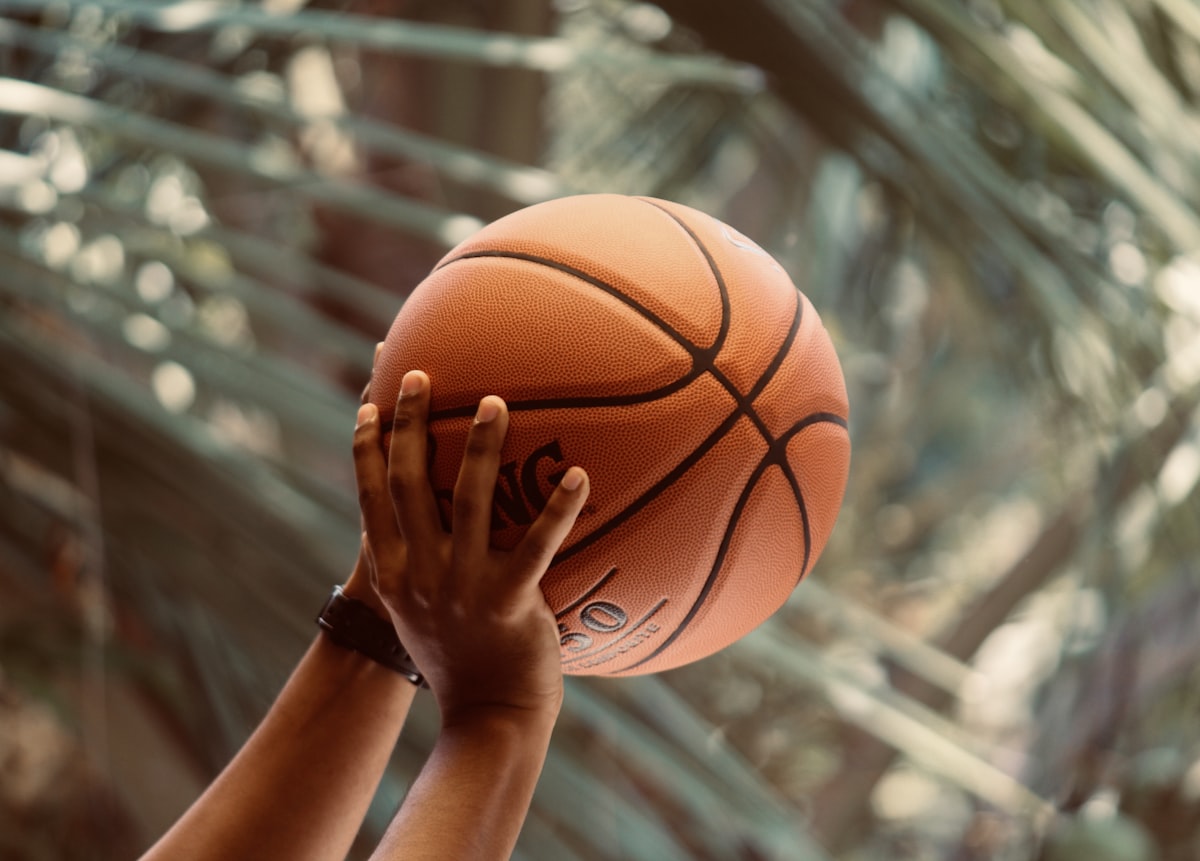 Man shooting a Spalding basketball. 
Image by Abhay Siby Mathew.  related to Level Up Your Sleep Game: Basketball Bedding for Twin Beds