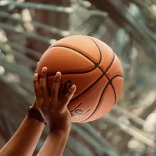 Man shooting a Spalding basketball. 
Image by Abhay Siby Mathew.  related to Level Up Your Sleep Game: Basketball Bedding for Twin Beds