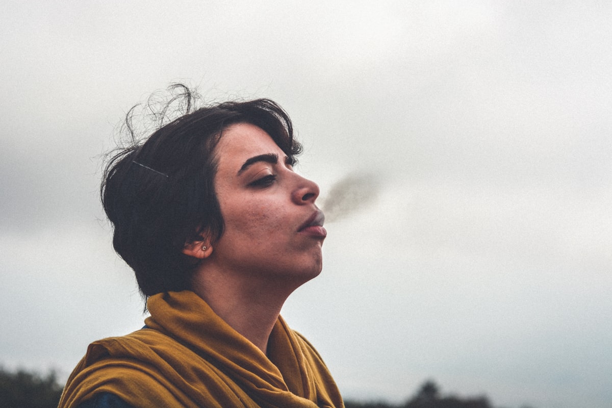 man wearing yellow top smoking related to Breathe New Life into Your Home Decor with the Charisma of a Small Teak Sideboard
